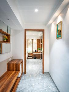 a hallway of a home with a table and a desk at Hotel Spencer-Navi Mumbai in Navi Mumbai