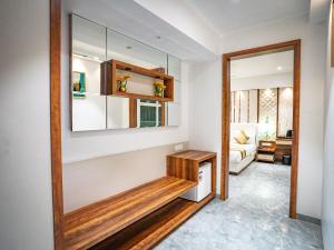 a living room with a mirror and a table at Hotel Spencer-Navi Mumbai in Navi Mumbai +48 photos