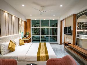 a bedroom with a large bed and a tv at Hotel Spencer-Navi Mumbai in Navi Mumbai