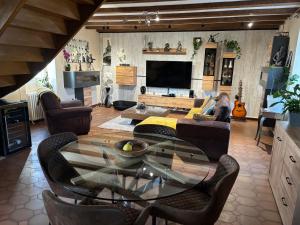 a living room with a glass table and chairs at Rocamadour in Rocamadour