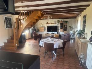 a living room with a dining table and a staircase at Rocamadour in Rocamadour