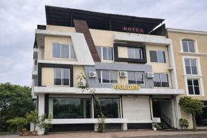 a hotel with a sign on the front of it at The Golden Wings Hotel in Dewās