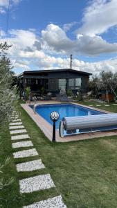 a house with a swimming pool in the yard at Akcavillagarden in İzmir
