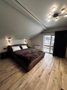 a bedroom with a bed and a ceiling fan at Grey House in Slavske +42 photos