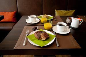 a table with two plates of food and two cups of coffee at Angler Hof in Süderbrarup