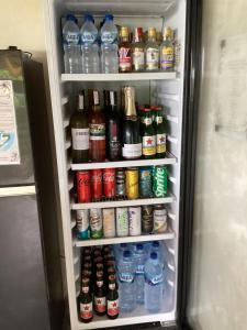 a refrigerator filled with lots of water and sodas at Les Terrasses Ceningan in Nusa Lembongan