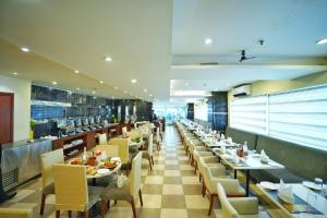 a dining room with tables and chairs and a restaurant at The Altruist Hitech Hotel in Hyderabad