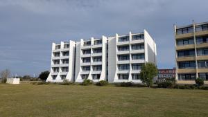 a large white building with a field in front of it at IFA Yachthafen Fehmarn in Fehmarn +11 photos