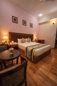 a hotel room with a bed and a table at Hotel Stiltstay in Greater Noida +36 photos