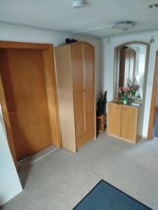 a room with wooden cabinets and a mirror at FeWo Waldblick in Goslar
