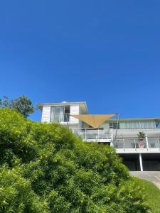 a house on top of a hill with a hedge at The Sullies in Morganʼs Bay