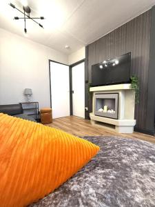 a living room with an orange pillow and a fireplace at Bayside in Bridlington