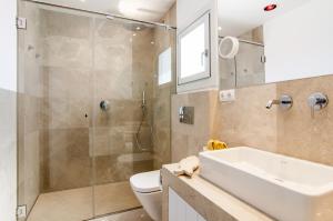 a bathroom with a shower and a sink and a toilet at Apartamento Sa Punta II in Portocolom
