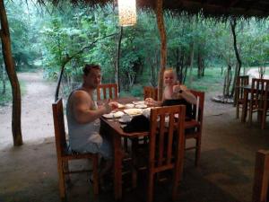 a man and a woman sitting at a table at Sky Forest in Habarana +41 photos