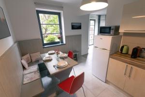 a small kitchen with a table and a refrigerator at Vila Krocinka in Prague