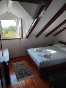 a bedroom with a large bed and a window at Rest House Stiniva in Podšpilje +21 photos
