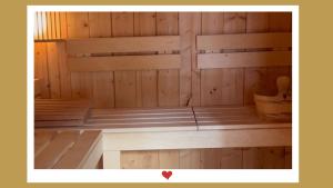 a sauna with wooden walls and benches in a room at Berghupferl-Alm mit Wellnessoase im Garten in Flintsbach am Inn