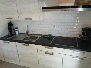 a kitchen with a sink and a counter top at Genieten in Wenduine in De Haan +19 photos