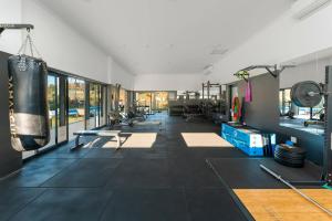 a gym with a punching bag and a boxing glove at Luxury Spa unit, Private Sauna, Central Ballito in Ballito