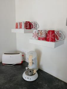 a kitchen with a mixer and christmas presents on shelves at Gites de la Bénardière in Vallières-les-Grandes