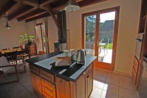 a kitchen with an island with a coffee maker on it at Les tilleuls in Glanges