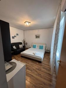 a living room with a bed and a couch at Casa Ana in Eforie Nord