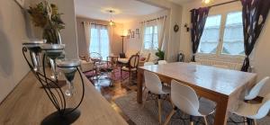 a living room with a table and chairs at LA MAISON DU MUGUET - Accueil Chevaux - Horse Friendly in Liart