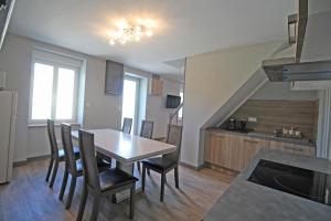 a kitchen and dining room with a table and chairs at Le paradis de caux in Magnac-Bourg
