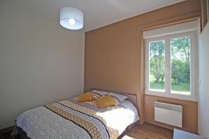 a bedroom with a bed and a window at Le paradis de caux in Magnac-Bourg +25 photos