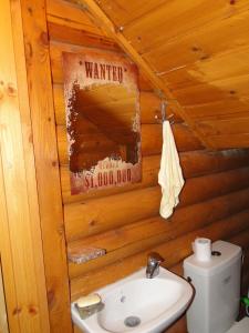 a bathroom with a toilet and a sink in a log cabin at Katafygio Chalet, Krikello in Kríkellon +33 photos