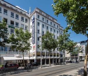 a large white building on a city street at Best Western Hotel zur Post in Bremen