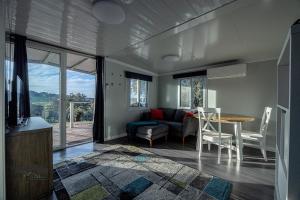 a living room with a couch and a table at Timbuktoo Escape in Glen Creek