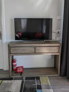 a flat screen tv sitting on top of a wooden table at Timbuktoo Escape in Glen Creek