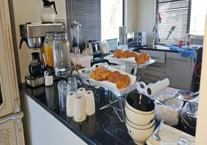 a kitchen with two trays of croissants on a counter at The White House at Plattekloof in Plattekloof