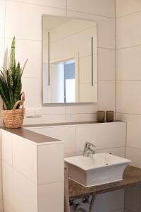 a bathroom with a sink and a mirror at FelsenSuite Panorama Essing in Essing