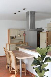 a kitchen with a wooden table and chairs at FelsenSuite Panorama Essing in Essing