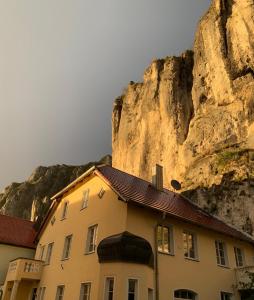 a building sitting in front of a mountain at FelsenSuite Panorama Essing in Essing