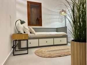 a bed in a room with a mirror and a table at Casa Manzella Apartments in Cinisi