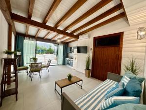 a living room with a blue couch and a table at Casa Manzella Apartments in Cinisi