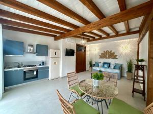 a kitchen and living room with a table and chairs at Casa Manzella Apartments in Cinisi