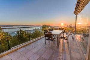 a patio with a table and chairs on a balcony at The Bluff Resort Apartments in Encounter Bay