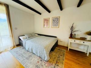 a bedroom with a bed with a rug and a table at La Terraza de Escarrilla, con piscina in Escarrilla +24 photos