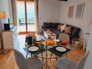 a living room with a table with fruit on it at La Terraza de Escarrilla, con piscina in Escarrilla