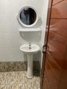 a bathroom with a white sink and a mirror at Don Det SODA RiverSide Guesthouse in Ban Donsôm Tai
