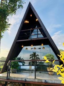 a triangle shaped building with windows and potted plants at Kurunda Estate Villa in Tangalle