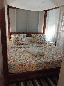 a bed with a pillow sitting on top of it at Le Bon Refuge in Le Lamentin