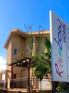 a building with a sign in front of it at Rainbow Home Coll Verd in Playa de Gandia