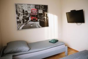 a bed in a room with a red double decker bus at Noclegi Kochlice in Kochlice