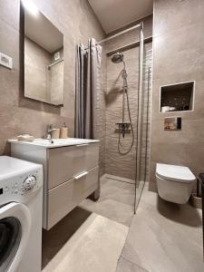 a bathroom with a toilet sink and a shower at Boljevic Apartments in Bečići +6 photos