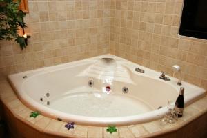 a bath tub with a bottle of wine in it at Among the cherry trees - B&B 1 Hermon in Metulla